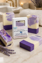 Purple and white soap bars with packaging on a marble surface, with a blurred bathroom background.