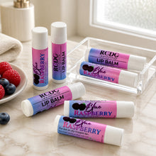 Lip balms with Raspberry and Blue Raspberry flavors on a marble surface.