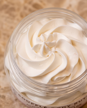 A close-up of a clear jar filled with whipped white body butter, showing the creamy texture in a swirled swirl pattern. The label at the bottom reads 'SOURFLE BODY BUTTER' and 'AUGUSTINE PARK'.