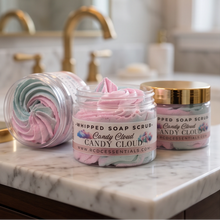 Three jars of SGC Essentials 'Candy Cloud' whipped soap scrub arranged on a white marble bathroom counter with gold faucets and a blurred mirror in the background.