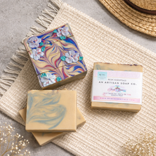 Artisan soap bars with marbled designs on a textured surface