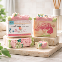 Artisan soap bars with pink and green swirls on a marble surface, featuring RCDC Essentials branding.