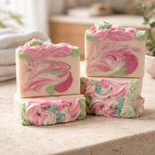 Pink and green marbled soap bars on a light surface