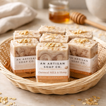 Basket of An Artisan Soap Co. oatmeal milk and honey soap bars on a neutral background